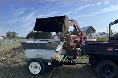 Loading-a-248PT-Spreader-behind-a-Toro-scaled